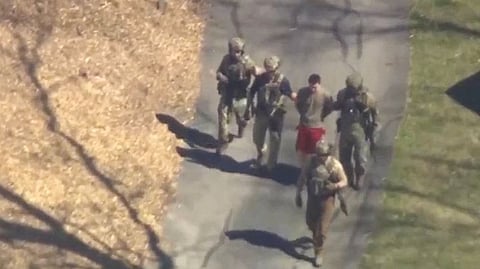 FBI agents arrest Jack Teixeira, an employee of the US Air Force National Guard, in connection with an investigation into the leaks online of classified U.S. documents, outside a residence in this still image taken from video in North Dighton, Massachusetts.