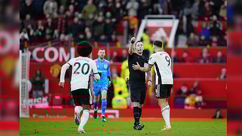 Referee Chris Kavanagh gestures as he sends off Fulham's Aleksandar Mitrovic, right, Willian, left, and manager Marco Silva, during the English FA Cup quarterfinal soccer match between Manchester United and Fulham at the Old Trafford stadium in Manchester, England, Sunday, March 19, 2023.
