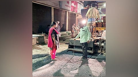 Officials inspecting road laying work