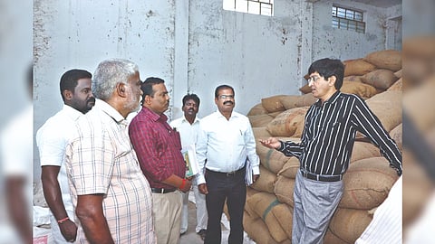 Principal Secretary J Radhakrishnan takes stock of a warehouse at Chekkanurani in Madurai district on Monday