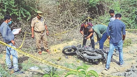 Police personnel inspect a two-wheeler at the site of the encounter in which jailed mafia Atiq Ahmad's son Asad was killed by the UP STF