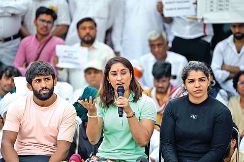 Wrestlers Bajrang Punia, Vinesh Phogat and Sakshi Malik address a news conference at Jantar Mantar on Friday