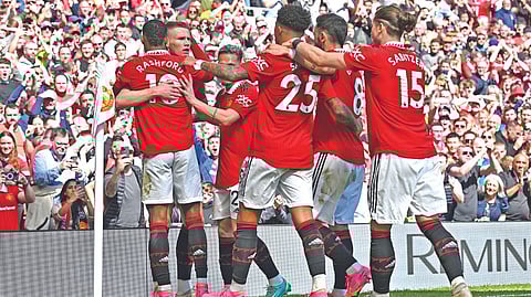 Manchester United players celebrate the opening goal