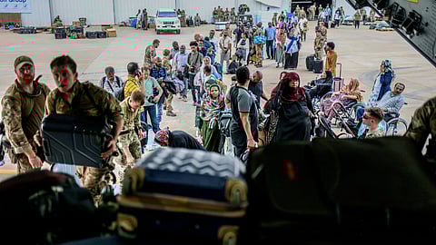 British Nationals prepare to be evacuated onto a RAF aircraft at Wadi Seidna Air Base, in Sudan, Thursday, April 27, 2023
