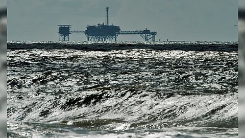 An oil and gas drilling platform stands offshore near Dauphin Island, Alabama