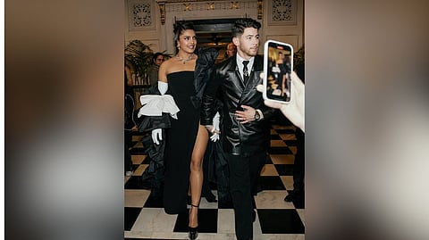 Priyanka Chopra and Nick Jonas? in Lagerfeld?s signature style wearing dark, tailored suits