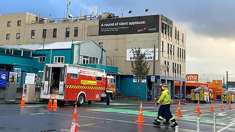 Firefighters work near a hostel in central Wellington