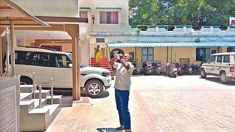 Suresh Babu, a former Congress councillor, blowing the conch at Ambur Municipal Office