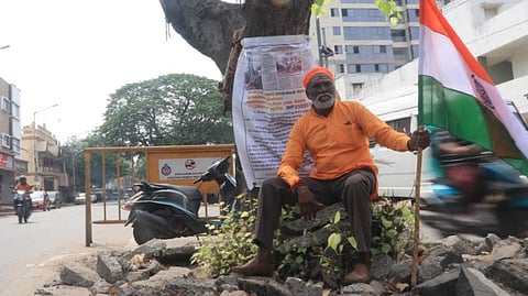 Rama Boopathy sitting under the tree and protesting