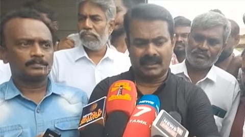 Seeman addressing the press