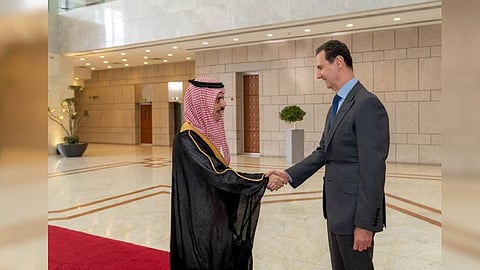 Syria's President Bashar al-Assad shakes hands with Saudi Foreign Minister Prince Faisal bin Farhan, in Damascus, Syria, in this handout released by SANA on April 18, 2023
