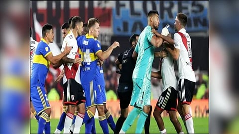 Players of Boca Juniors and River Plate fight during the match