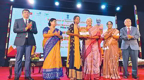Union Finance Minister Nirmala Sitharaman handing over a job offer to one of the beneficiaries of Rozgar Mela at a function in Chennai on Tuesday