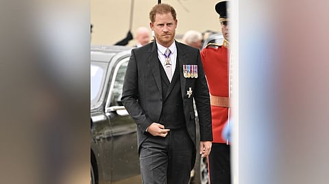 Prince Harry in Dior custom-made black suit.
