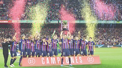 Barcelona players celebrate lifting the La Liga trophy at Camp Nou on Saturday