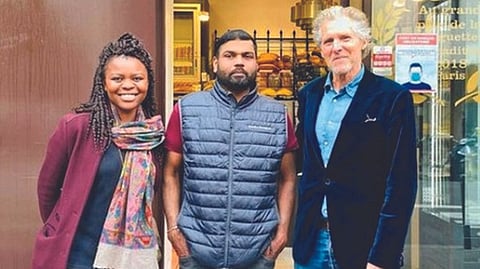 Tharshan in front of his bakery in Paris