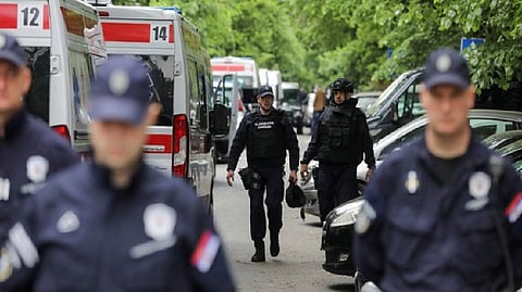 Police officers secure area after 14-year-old boy opened fire in Belgrade
