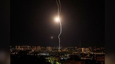 Explosion of a missile is seen in the sky over the city during a Russian missile strike