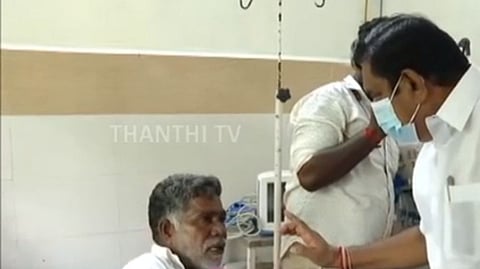Edappadi K Palaniswami talking to a victim