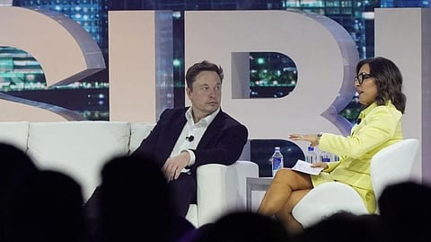 Twitter CEO Elon Musk, center, speaks with Linda Yaccarino, chairman of global advertising and partnerships for NBC, at the POSSIBLE marketing conference, Tuesday, April 18, 2023, in Miami Beach, Fla.