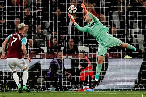 Stoke City's Jack Butland in action with West Ham United's Marko Arnautovic
