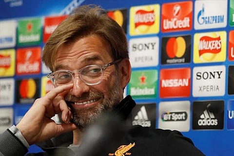Liverpool manager Juergen Klopp reacts as the interpreter speaks during the press conference