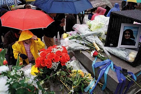 People pay their respects at a makeshift memorial on Yonge Street after a van that attack