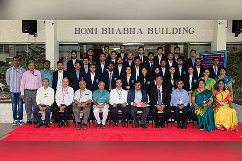 The 29 trainees who graduated this year with the guests pose for a group photo after the ceremony