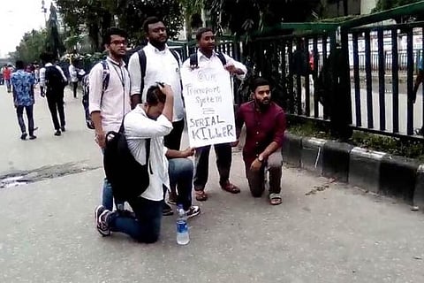 People with a placard during a protest over recent traffic accidents that killed a boy and a girl