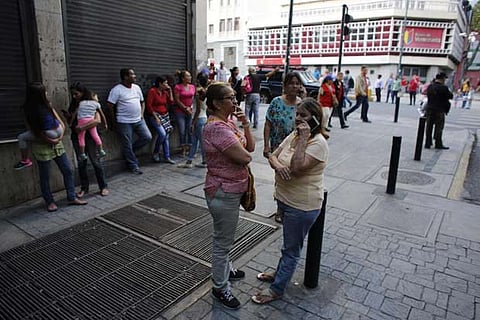 Residents stand outside after a powerful earthquake shook eastern Venezuela