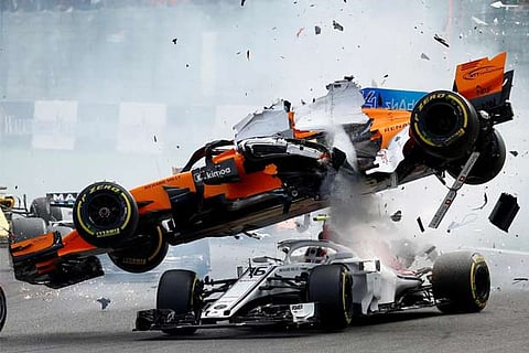 McLaren's Fernando Alonso and Sauber's Charles Leclerc crash at the first corner