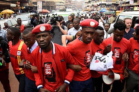 Ugandan musician turned politician, Robert Kyagulanyi (C) leads activists during a demonstration