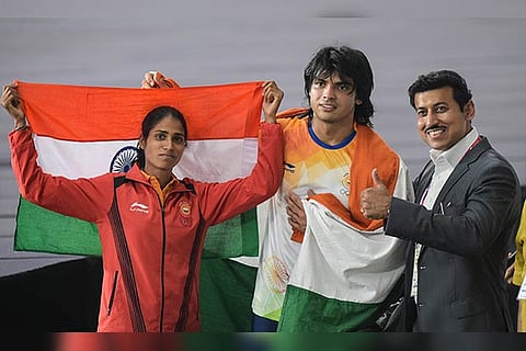 Minister Rajyavardhan Singh with Neeraj Chopra (C) and Sudha Singh (L)