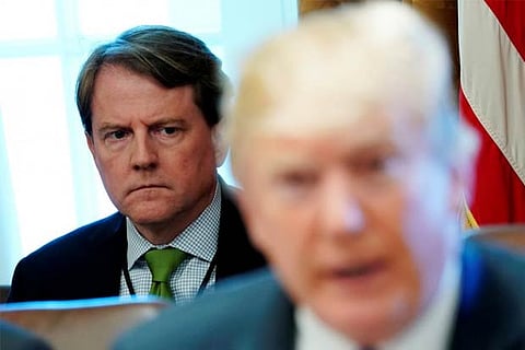 White House Counsel Don McGahn sits behind U.S. President Donald Trump