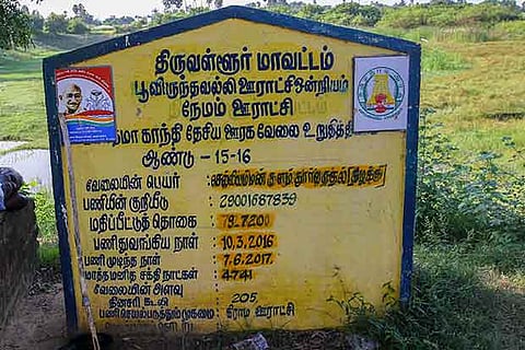 A board with details of the eco-restoration works carried out at a temple tank in Nemam village