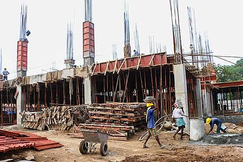 Workers seen engaged in construction of the new DPI complex, in Chennai recently