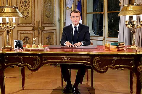 Macron vows tax relief, urges calm in bid to quell protests