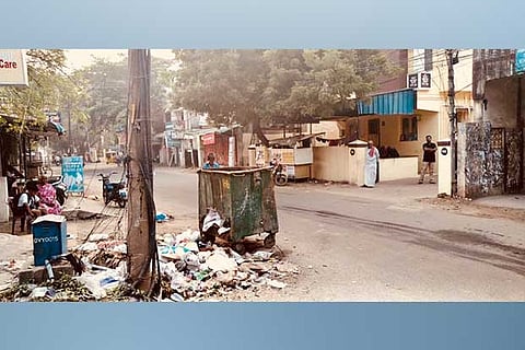 The garbage bin with a hole on its side on Gandhi Road in Velachery