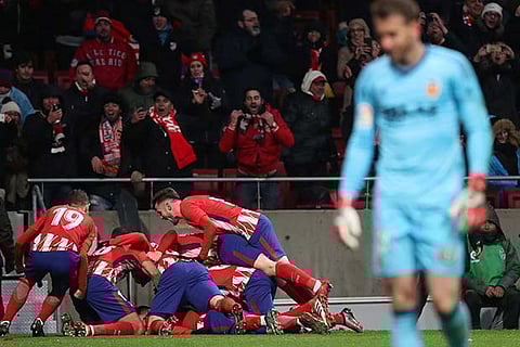 Atletico Madrid team mates celebrate after scoring their first goal