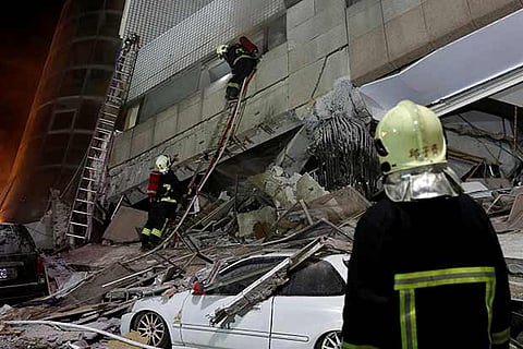 A fireman works at a collapses building after earthquake hit Hualien, Taiwan