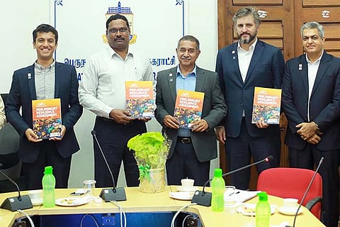 Corporation Commissioner D Karthikeyan (in white shirt) and other officials with the report