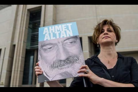 A protester holds the photo of prominent turkish journalist Ahmet Altan