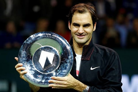 Roger Federer holds the trophy after winning against Grigor Dimitrov