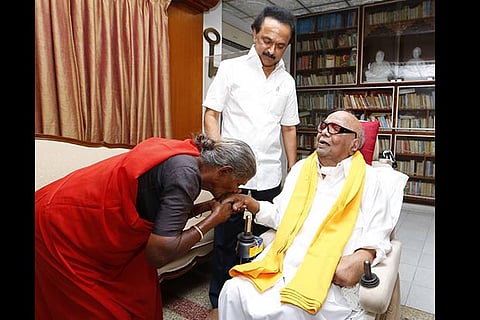 74-yr-old Pappathi, a die-hard cadre, kisses the hand of DMK president M Karunanidhi