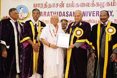 Musician TV Gopalakrishnan (in white robes) being awarded the PhD by Governor Banwarilal Purohit
