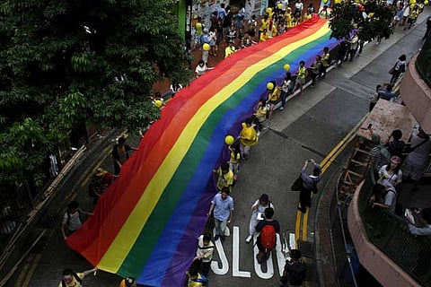 Participants march with a banner with rainbow colours during the annual pride parade in Hong Kong