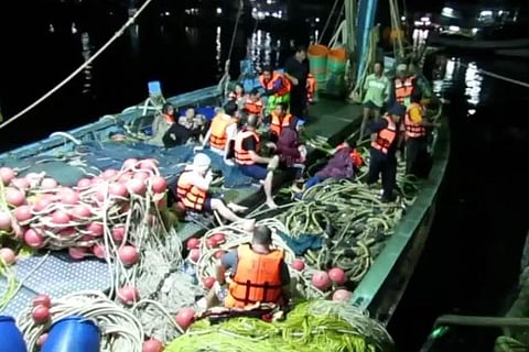 Rescued people in life jackets after a boat they were travelling in capsized off Phuket