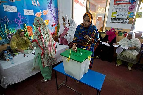 A Pakistani woman casts her vote at a polling station for the parliamentary elections in Islamabad