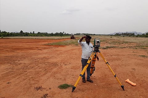 Official of a private firm conducts survey at airport site on Friday