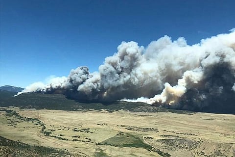 Smoke is seen from a fire in this aerial shot above Cimarron